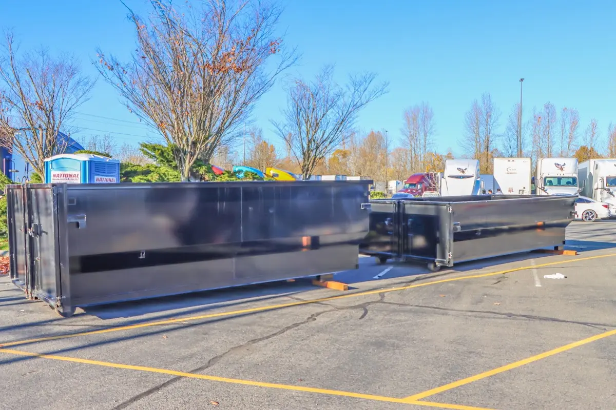 Professional dumpster rental service with roll-off container on residential driveway in Minnetonka